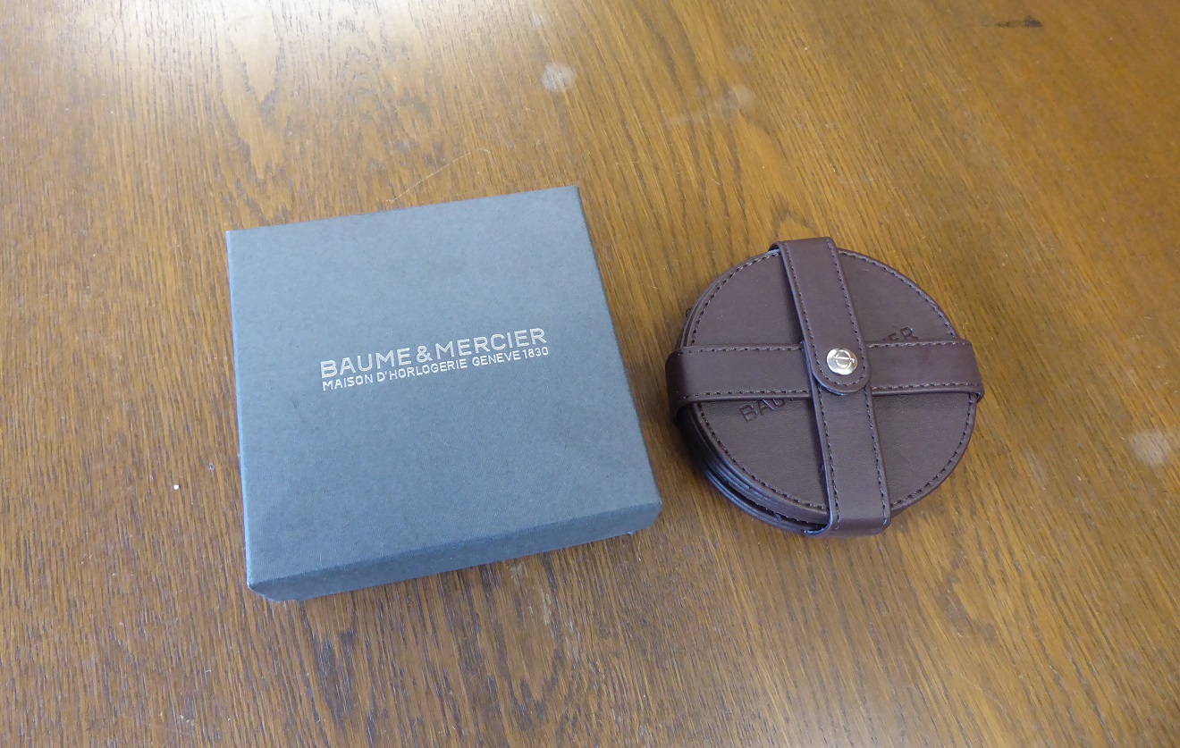 A Set Of Six Baume & Mercier Leather Coasters