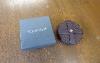 A Set Of Six Baume & Mercier Leather Coasters