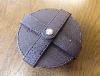 A Set Of Six Baume & Mercier Leather Coasters