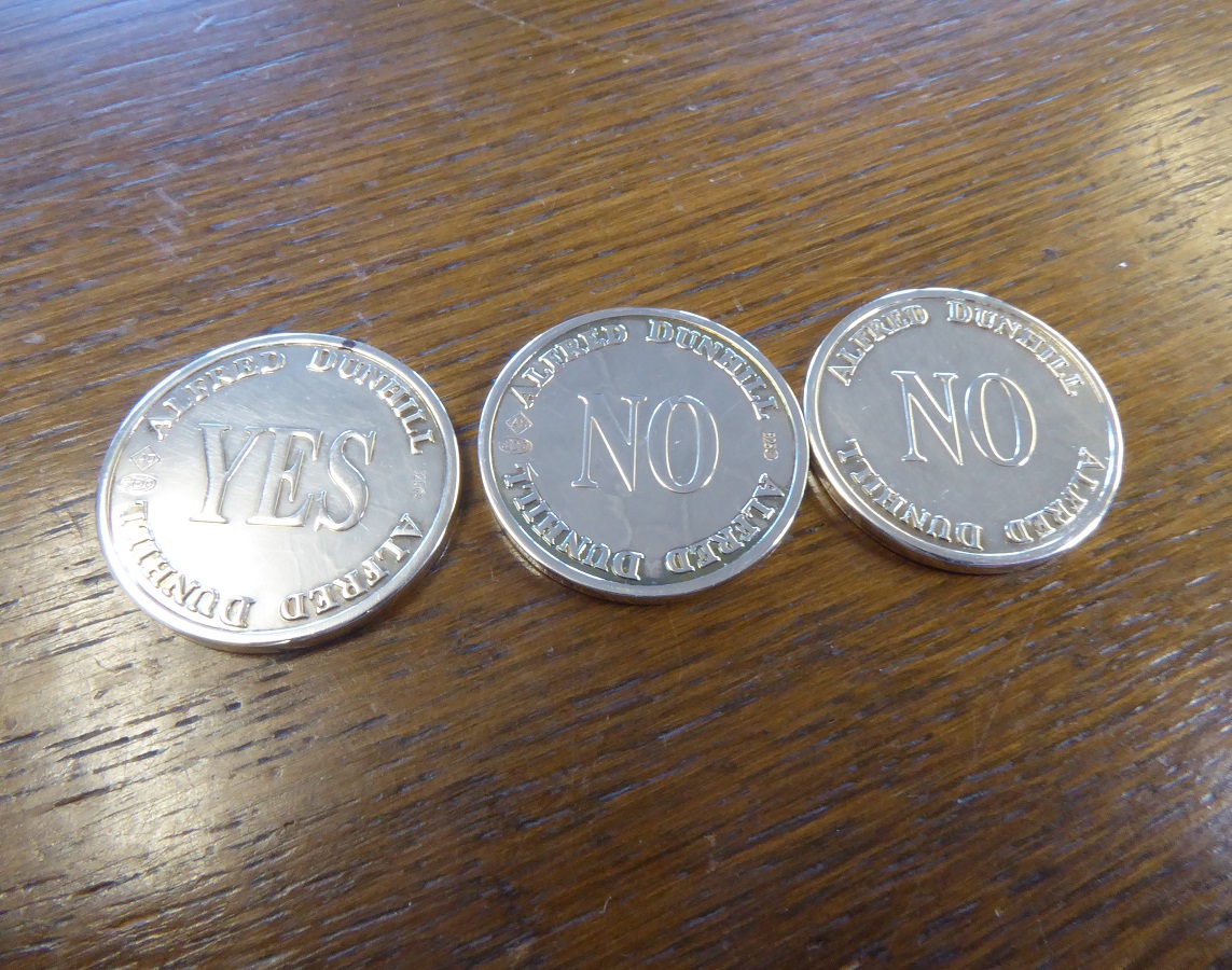 An Alfred Dunhill Yes / No Sterling Silver Coin Set